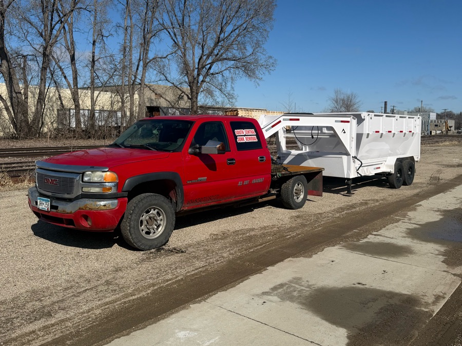 The South Central Hauling and Junk Removal truck with its dumpster trailer