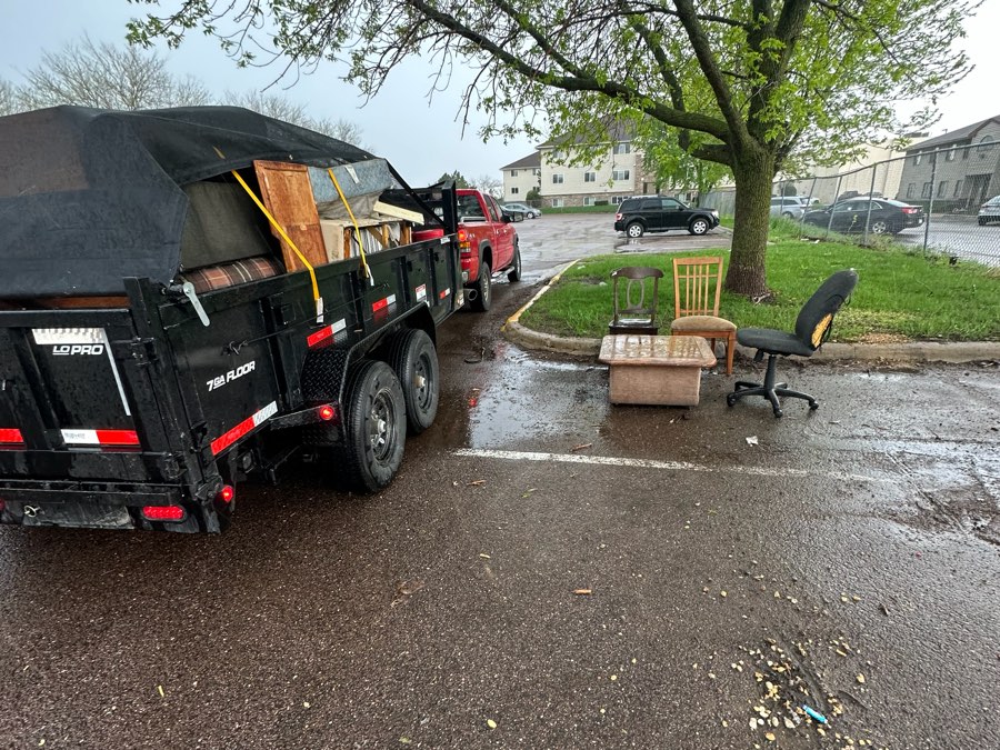 Truck and dump trailer loaded during an apartment turnover cleanout