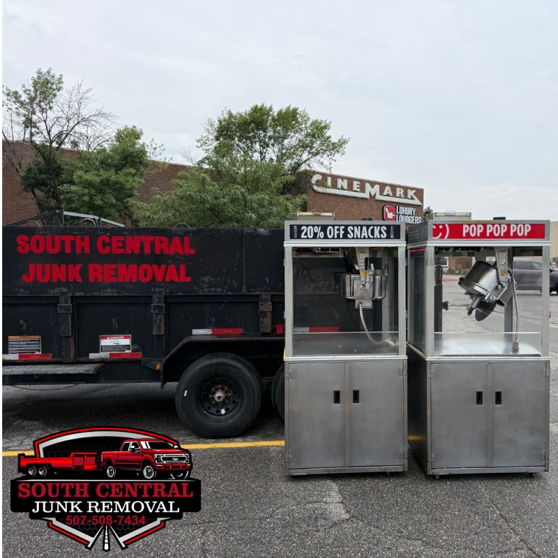 Two movie theater popcorn machines beside the South Central dump trailer